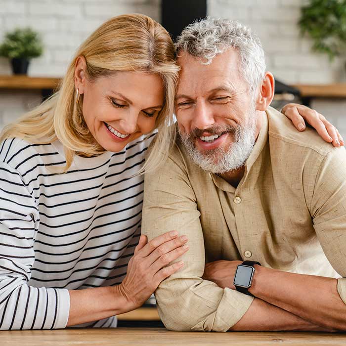 Couple Laughing With Dental Bridges